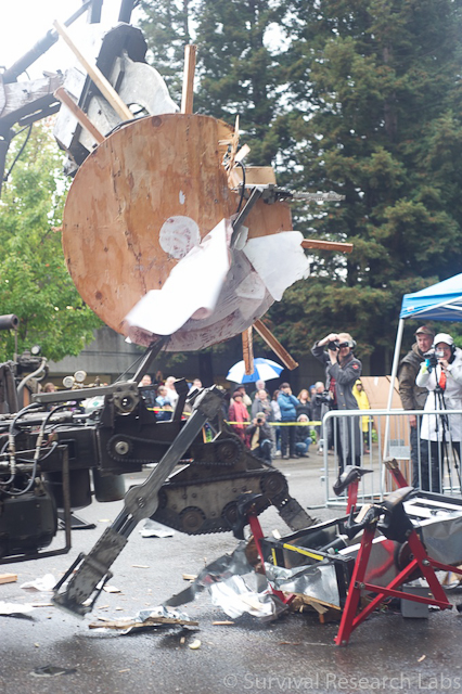 Big Arm lifts part of the Stick Wheel Robot over the capsized BugBot and Running  Machine